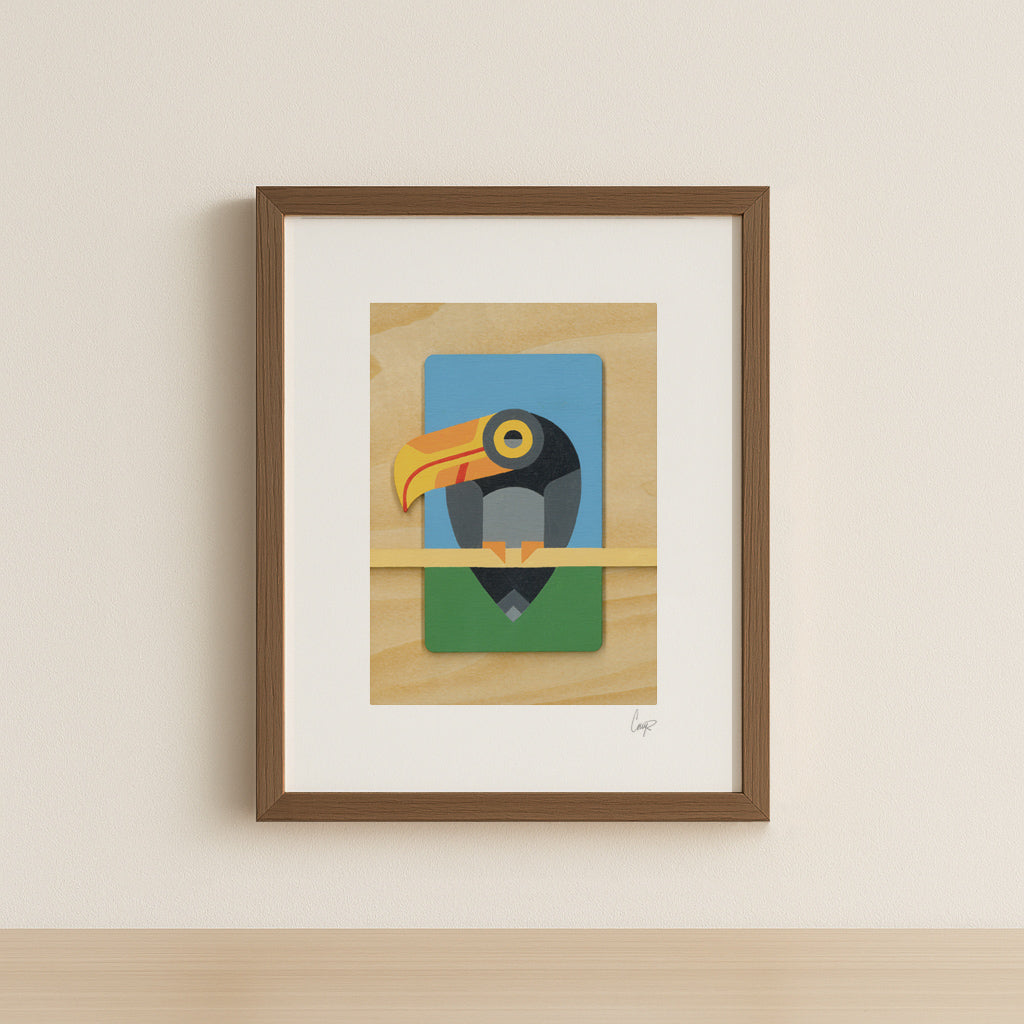 A geometric abstract toucan art print painted in bold primary colors perched on a branch with natural wood grain details. Shown in a simple walnut frame.