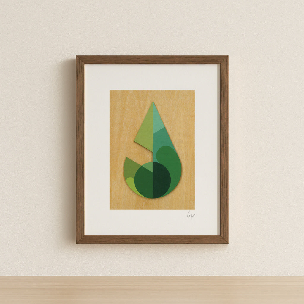 Framed abstract green geometric leaf art print on a wood grain background with a simple walnut frame.