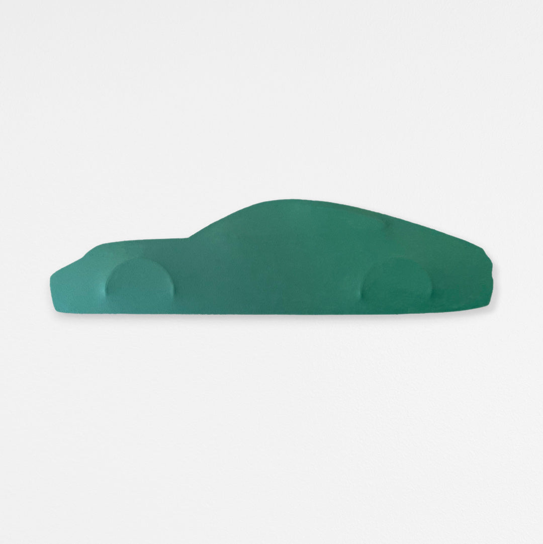 Handcrafted car silhouette, custom stretched canvas wall art with single green color tone hanging on a white wall.