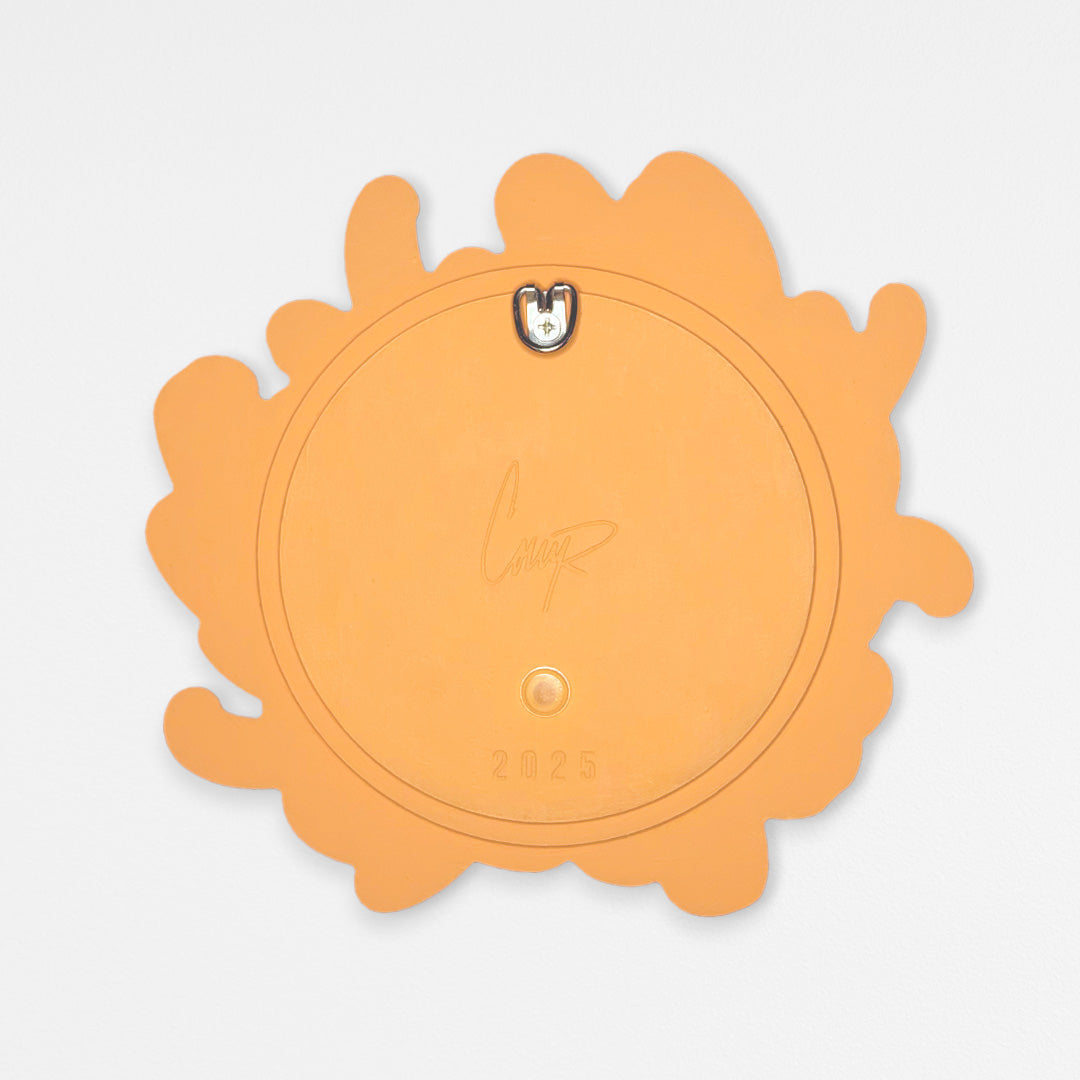 Back view of chrysanthemum-shaped wood wall sculpture painted in bright orange. Photographed against a white background featuring layers of wood and D-ring hardware.
