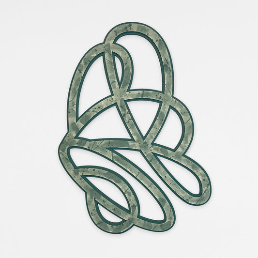 A decorative abstract knot 3D wall art design with a green and gray paint splatter pattern, hanging on a light gray background.
