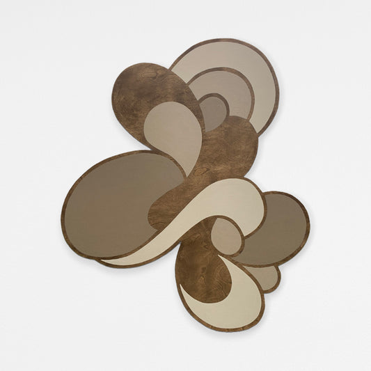 An abstract dark walnut stained wall art piece featuring layered organic shapes in beige, and cream tones, set against a plain light gray background.