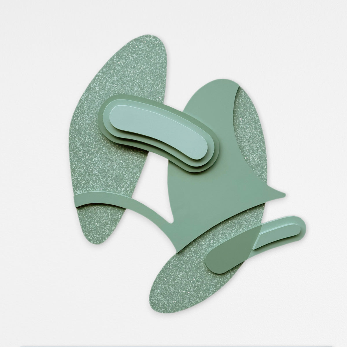 An abstract sage green wall art piece featuring layered organic shapes, and textured accented layers, set against a plain light gray background.