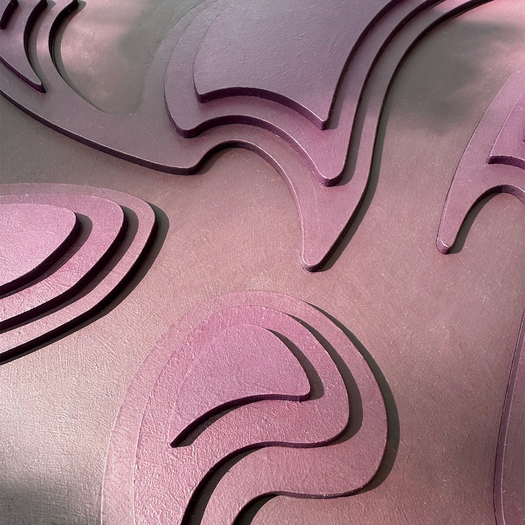 Close-up of an organic shaped surface with wavy patterns made from layers of dark purple wood pieces.