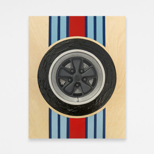 Hand-painted black porsche fuchs wheel wood wall art with textured tire and martini racing stripes behind the wheel. Hanging on a white wall.