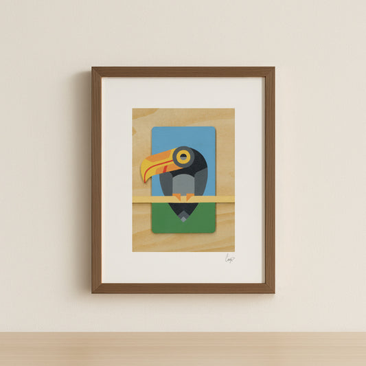 A geometric abstract toucan art print painted in bold primary colors perched on a branch with natural wood grain details. Shown in a simple walnut frame.